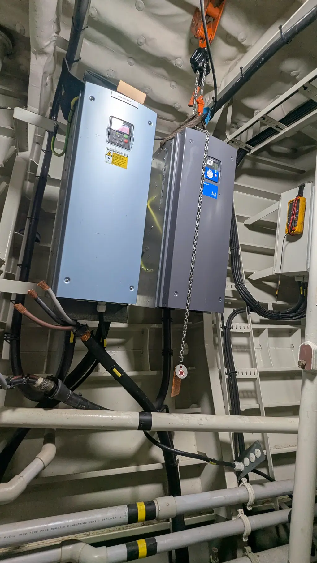 New frequency drive mounted on the wall, a chain hoist alongside