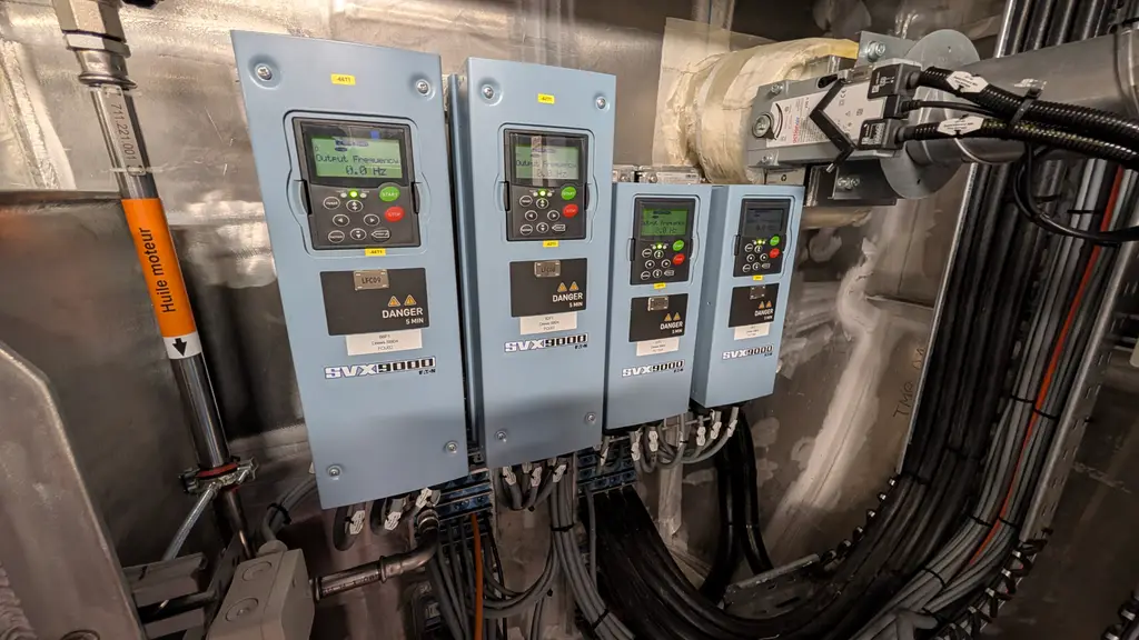 Four frequency drives mounted on a stainless steel wall