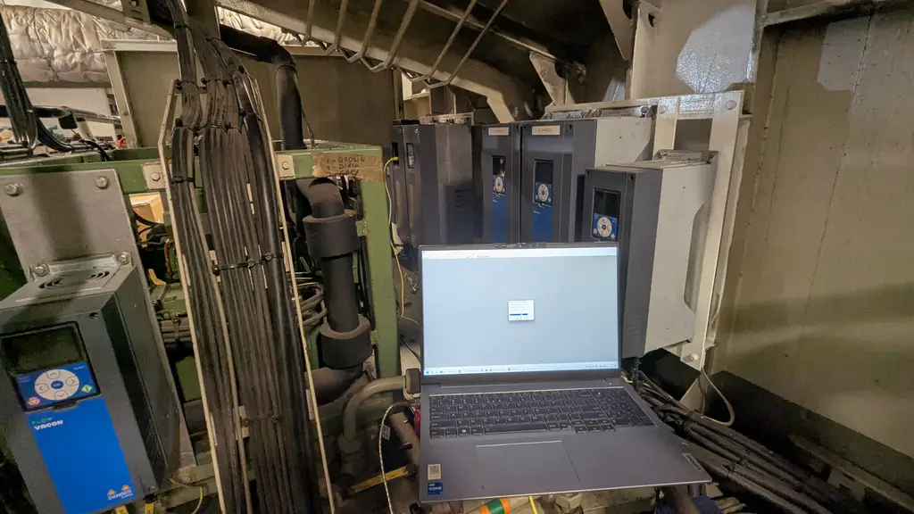 Laptop on a rack in an engine room, frequency drives on the wall