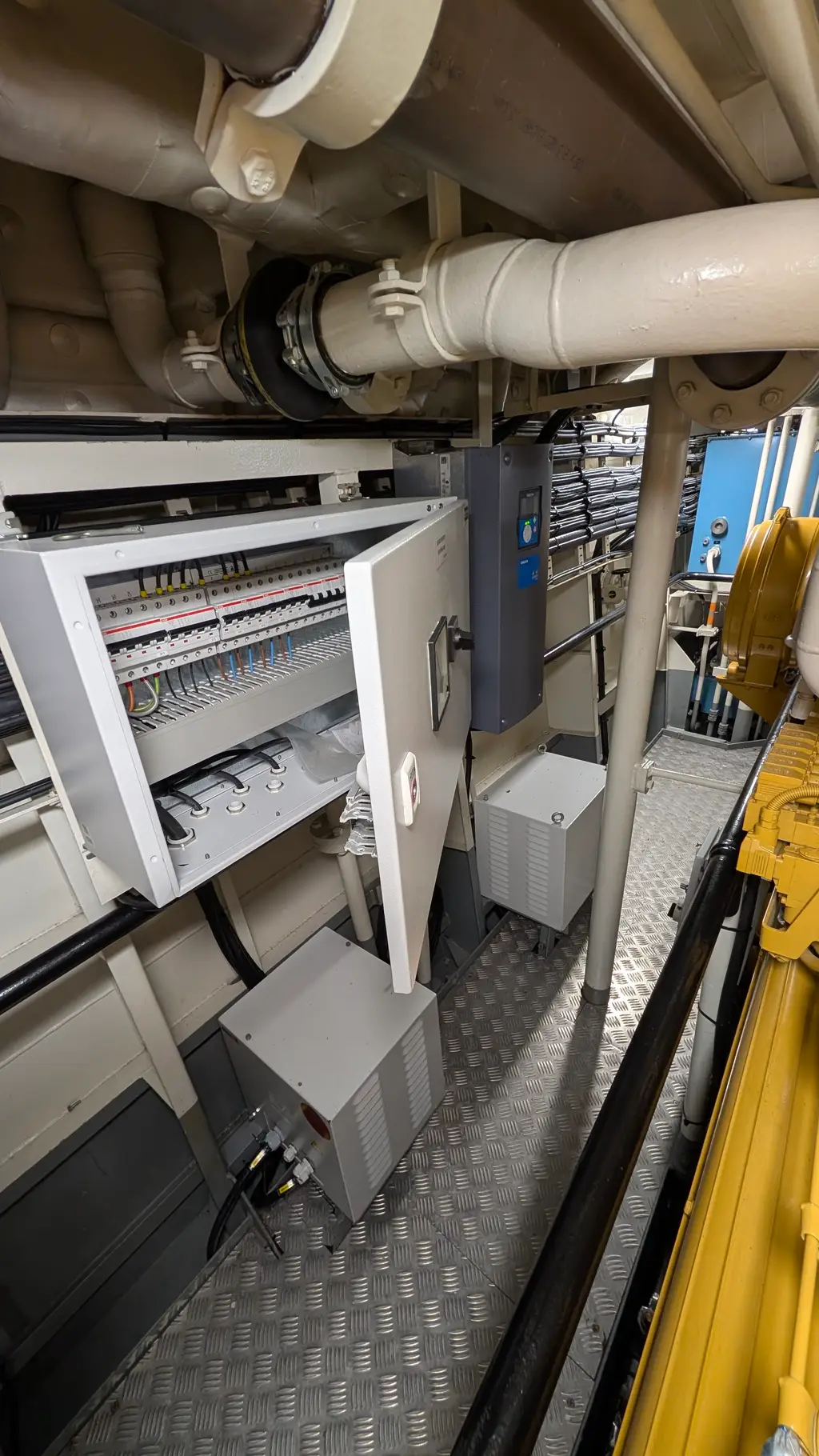 Open cabinet with terminal rails and a small junction box below