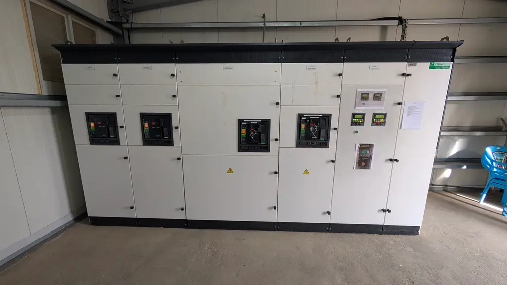 Row of switchboard panels with controllers