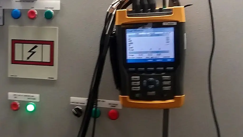 Power analyser held in front of a panel