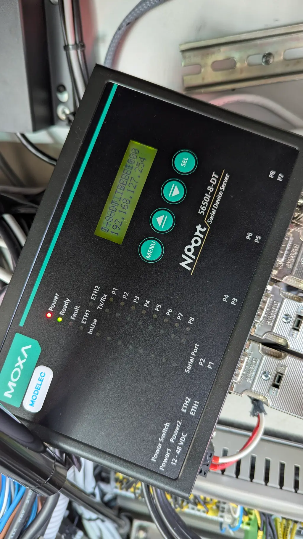 Close-up of a MOXA NPort serial device server with its status LEDs